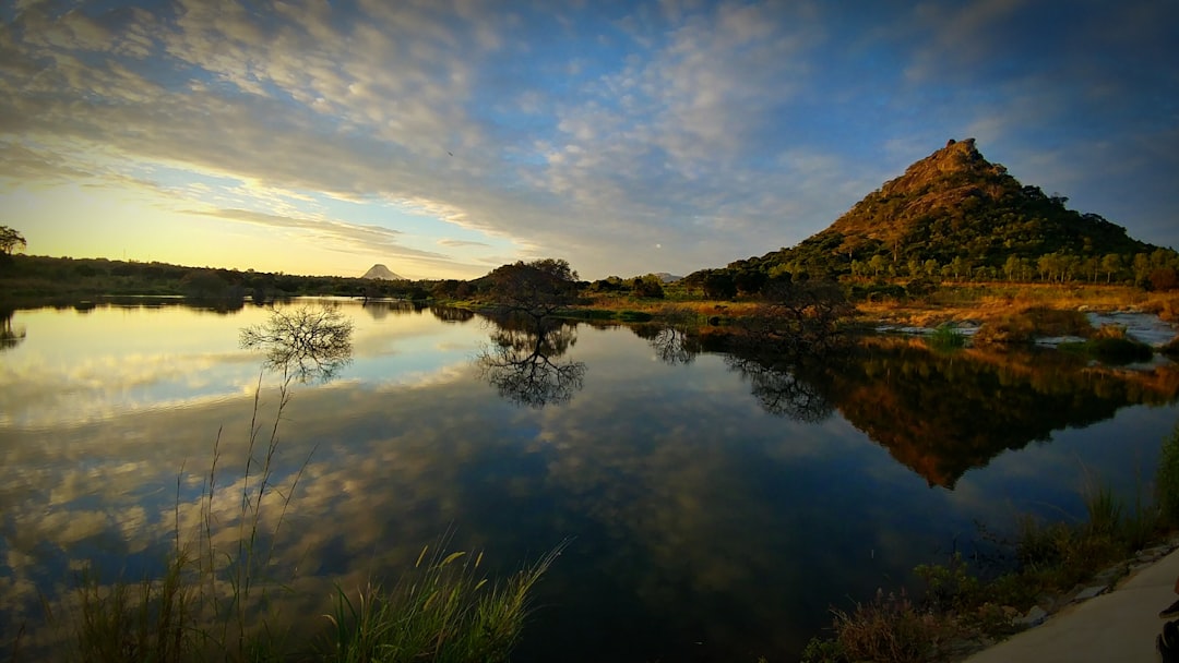 The mountain and sky reflect in tranquil water.
